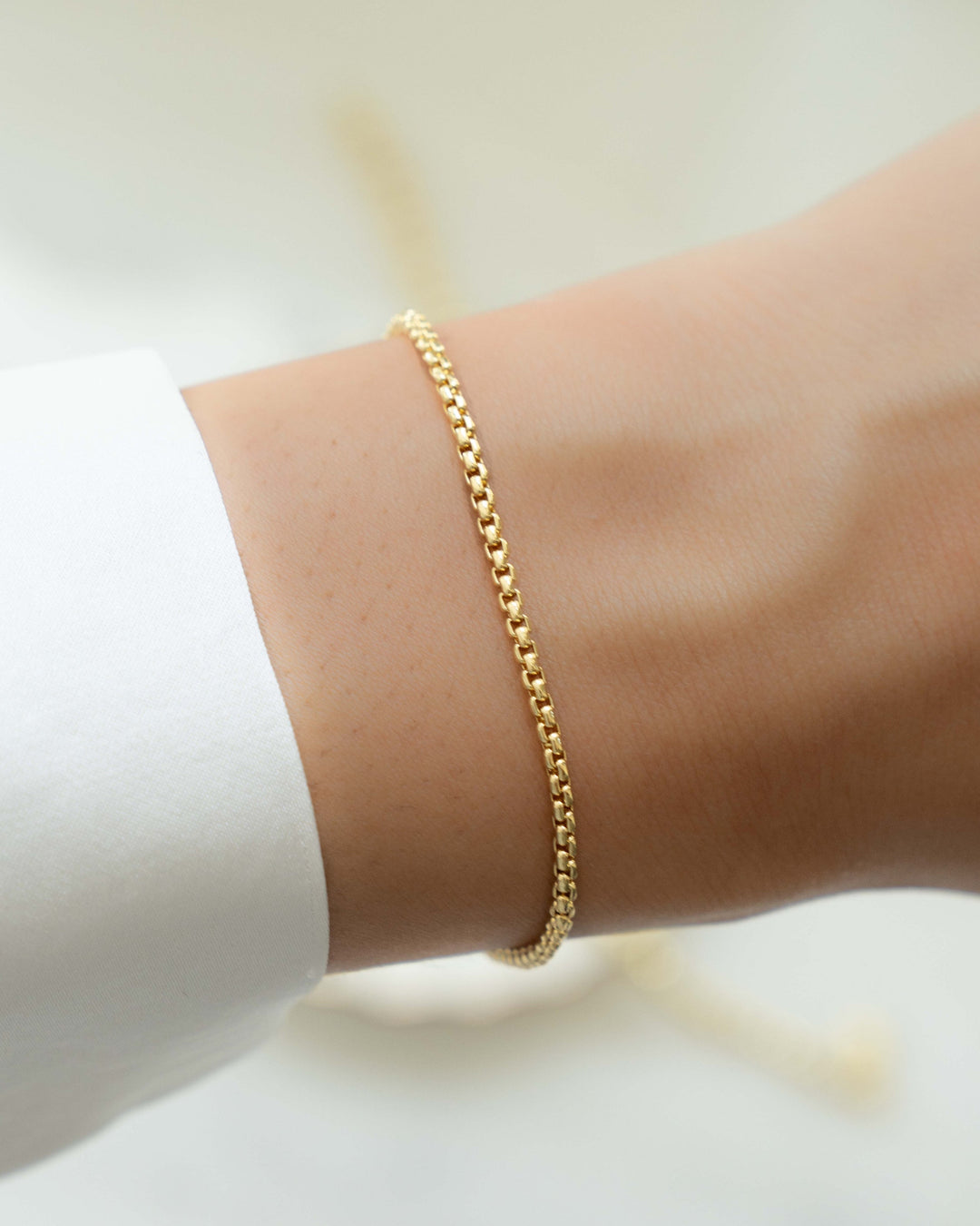 Gold minimalist thin chain bracelet on model
