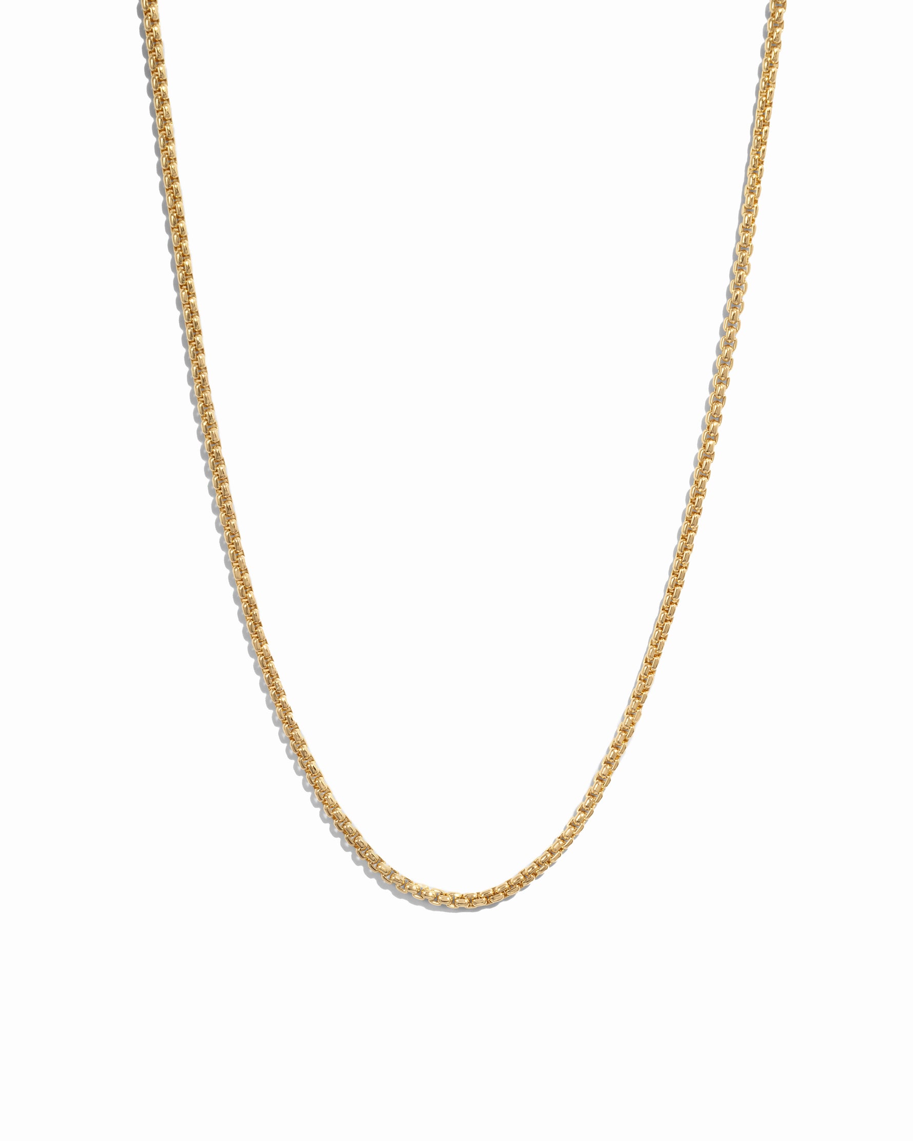 Gold chain necklace on a white background