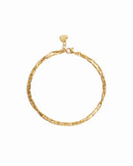 Closeup image of dainty gold bracelet set 