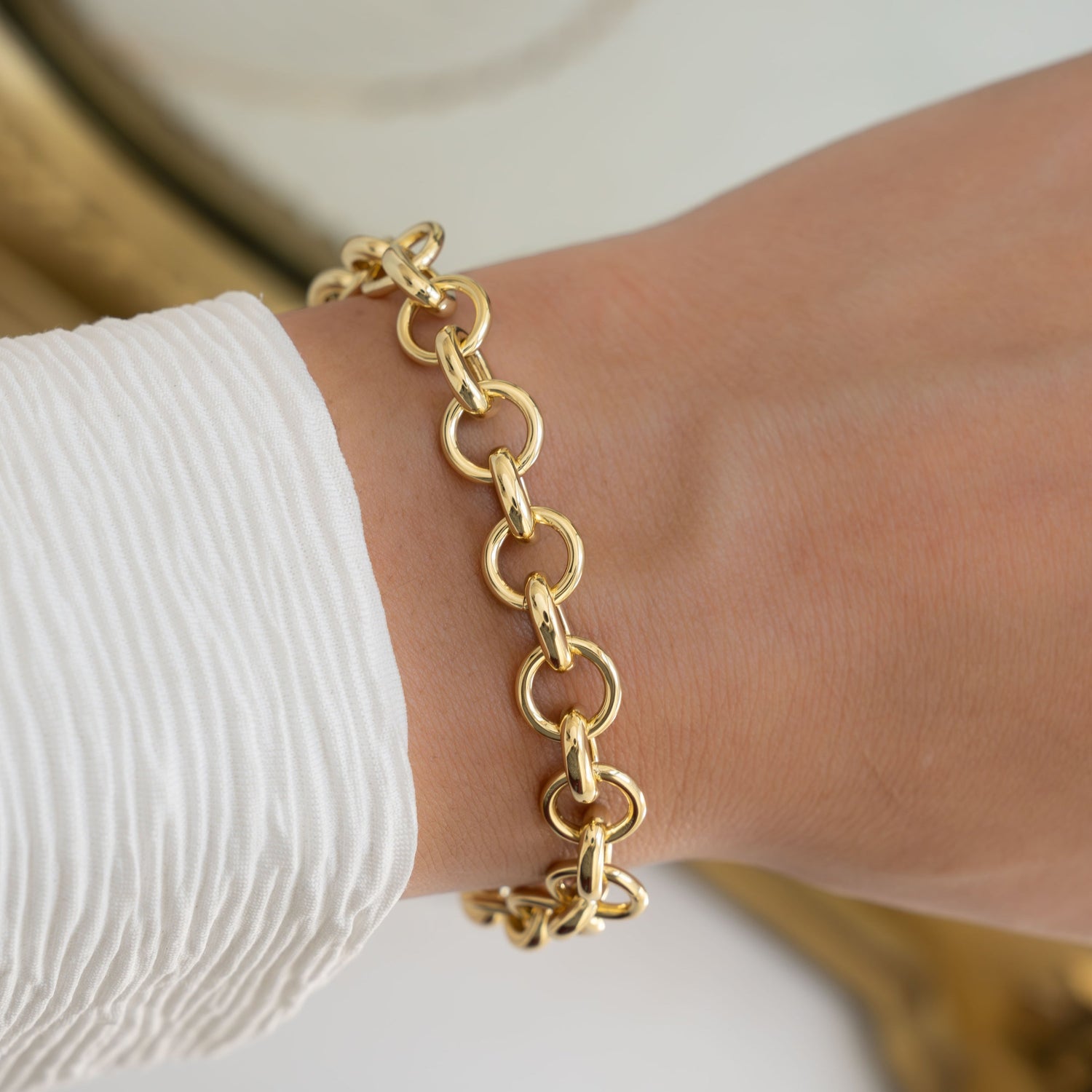 Model wearing gold chain link bracelet