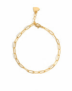Gold paperclip chain bracelet on white background
