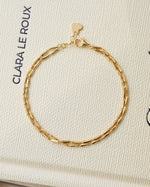 Gold minimalist bracelet set on coffee table book