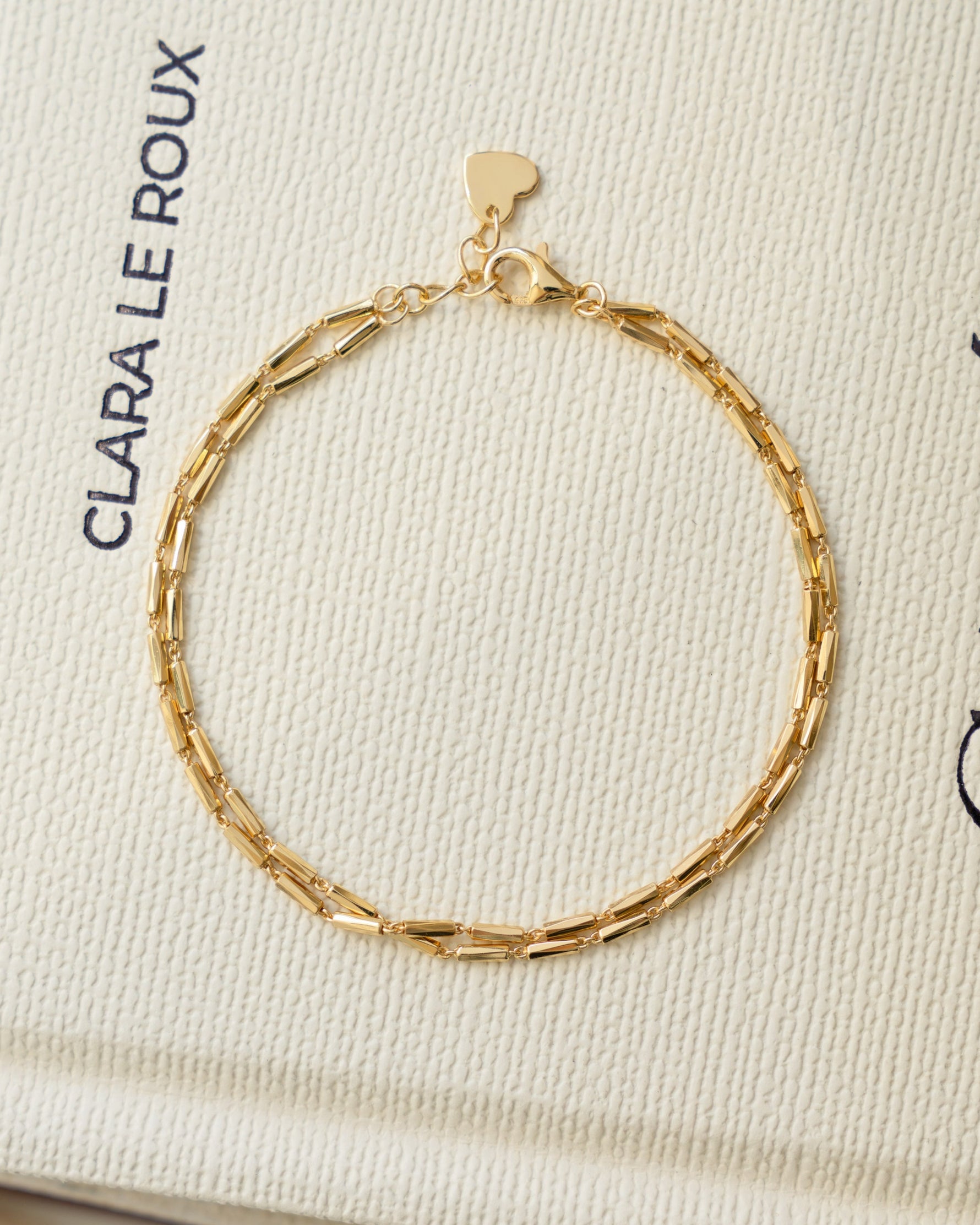 Gold minimalist bracelet set on coffee table book