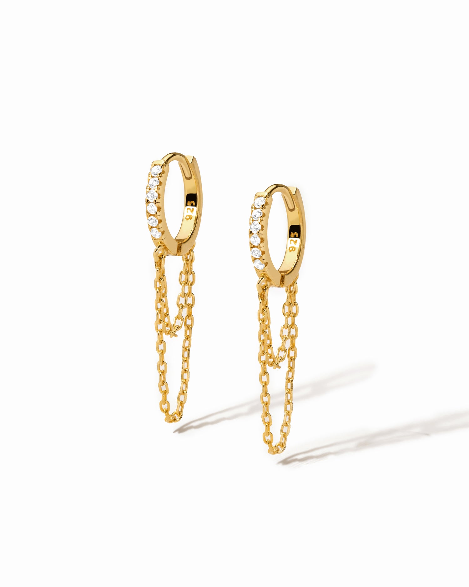 Gold hoop earrings with chain extensions on a white background