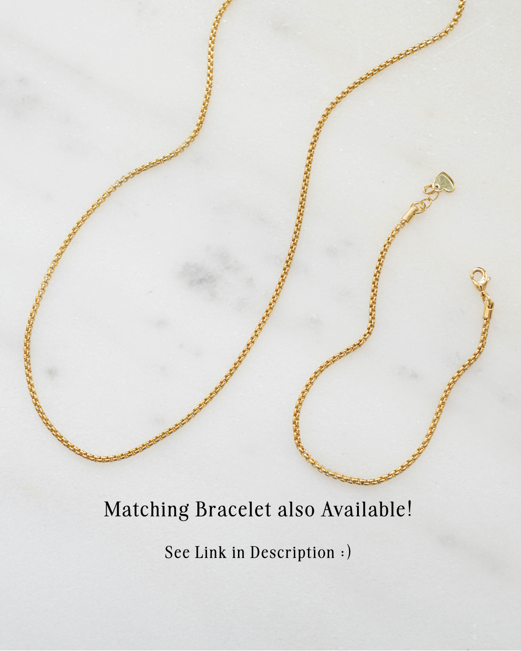 Gold chain necklace on a marble surface with text about a matching bracelet.