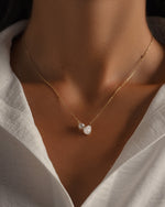 Gold chain pearl necklace on model