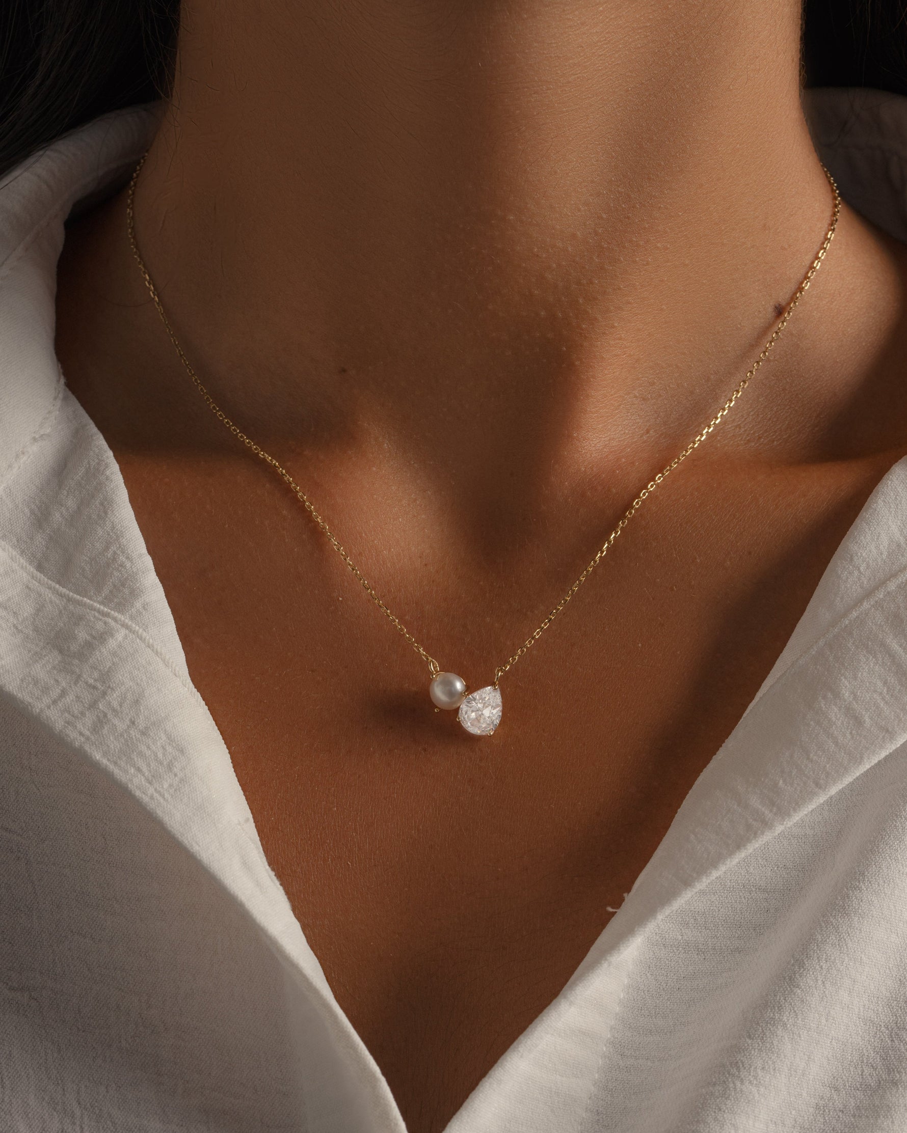 Gold chain pearl necklace on model