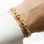 Model wearing gold chain bracelet with cz diamonds