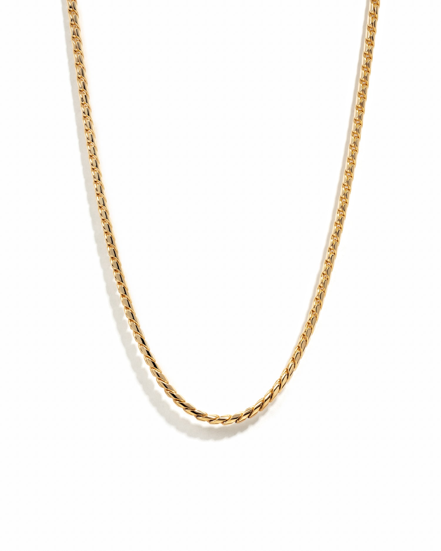 Gold chain necklace on a white background