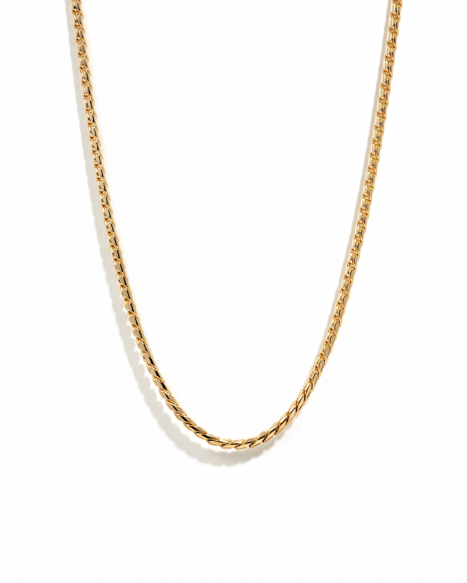 Gold chain necklace on a white background
