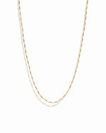 Gold chain necklace on a white background