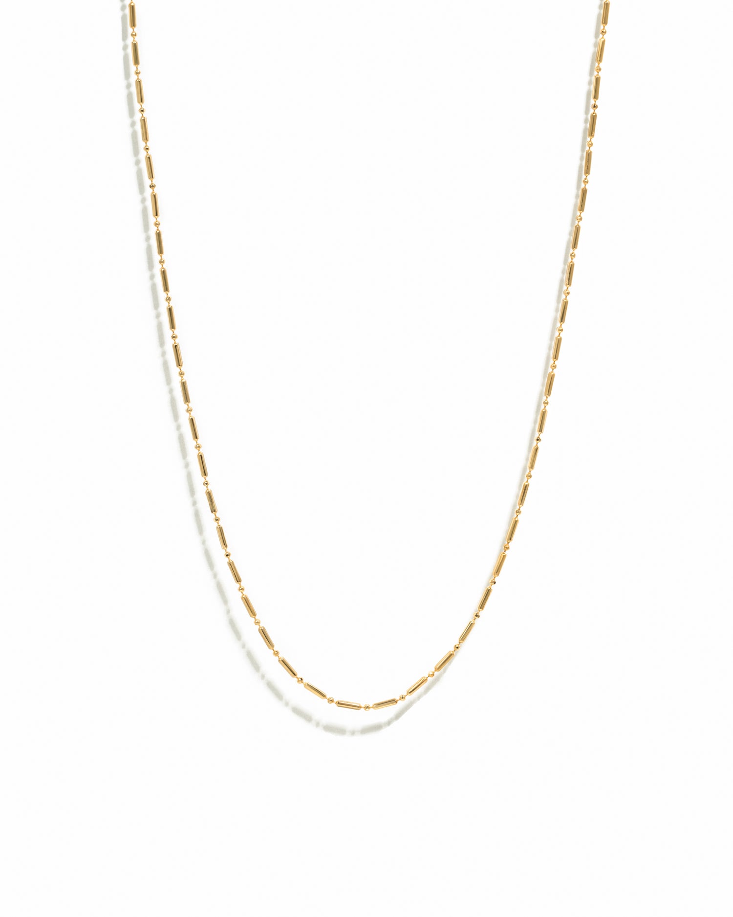 Gold chain necklace on a white background