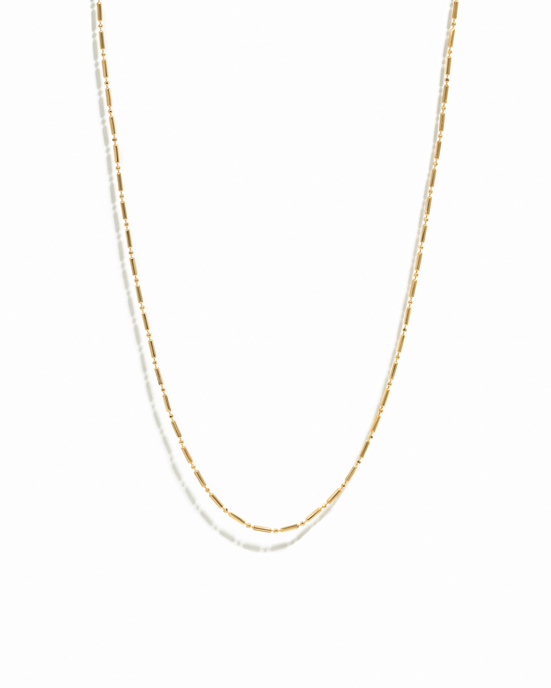 Gold chain necklace on a white background