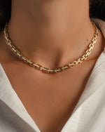 Model wearing gold choker necklace 