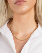 Gold rope chain necklace on model