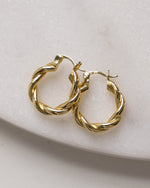 Gold chunky spiral hoop earrings.