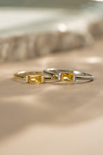 Gold birthstone jewelry featuring a gold birthstone ring and a matching sterling silver gemstone ring