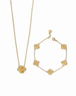 Gold pendant clover necklace and clover bracelet set on a white background
