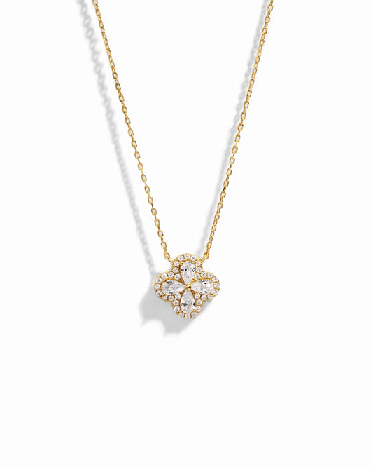 Close-up of four leaf clover pendant inspired by Van Cleef, highlighting intricate diamond details of pear shaped stones made of cubic zirconia.