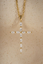 Diamond pendant with marquise cut stones on a beige background