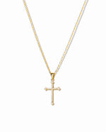 closeup image of gold cross pendant necklace 