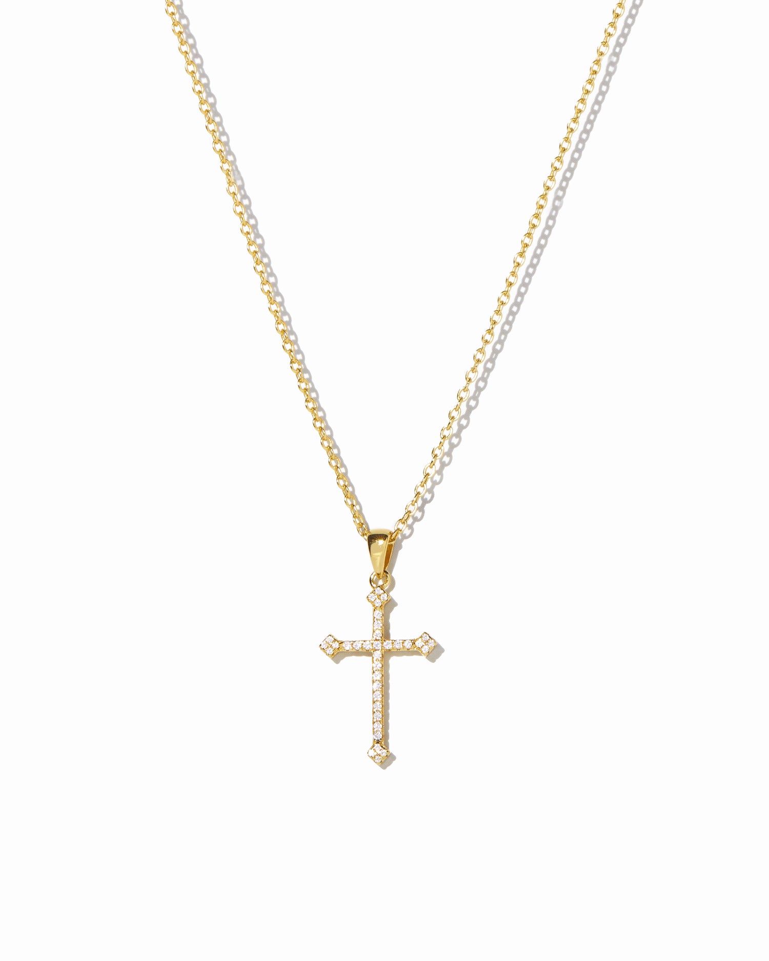 closeup image of gold cross pendant necklace 