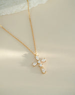 Gold gemstone necklace on beige background