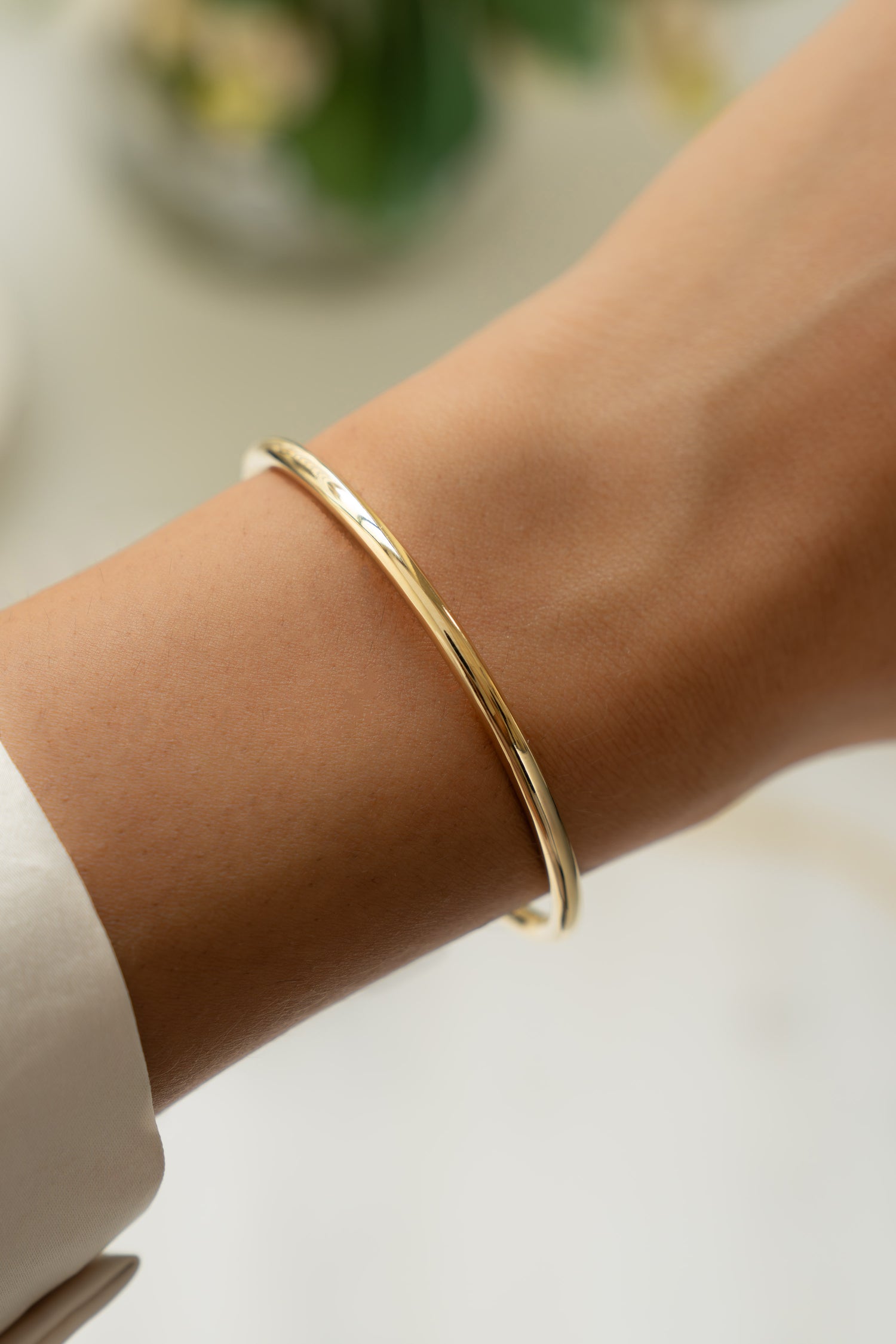 model wearing an adjustable gold cuff bracelet