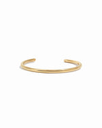 Gold cuff bracelet on a white background 
