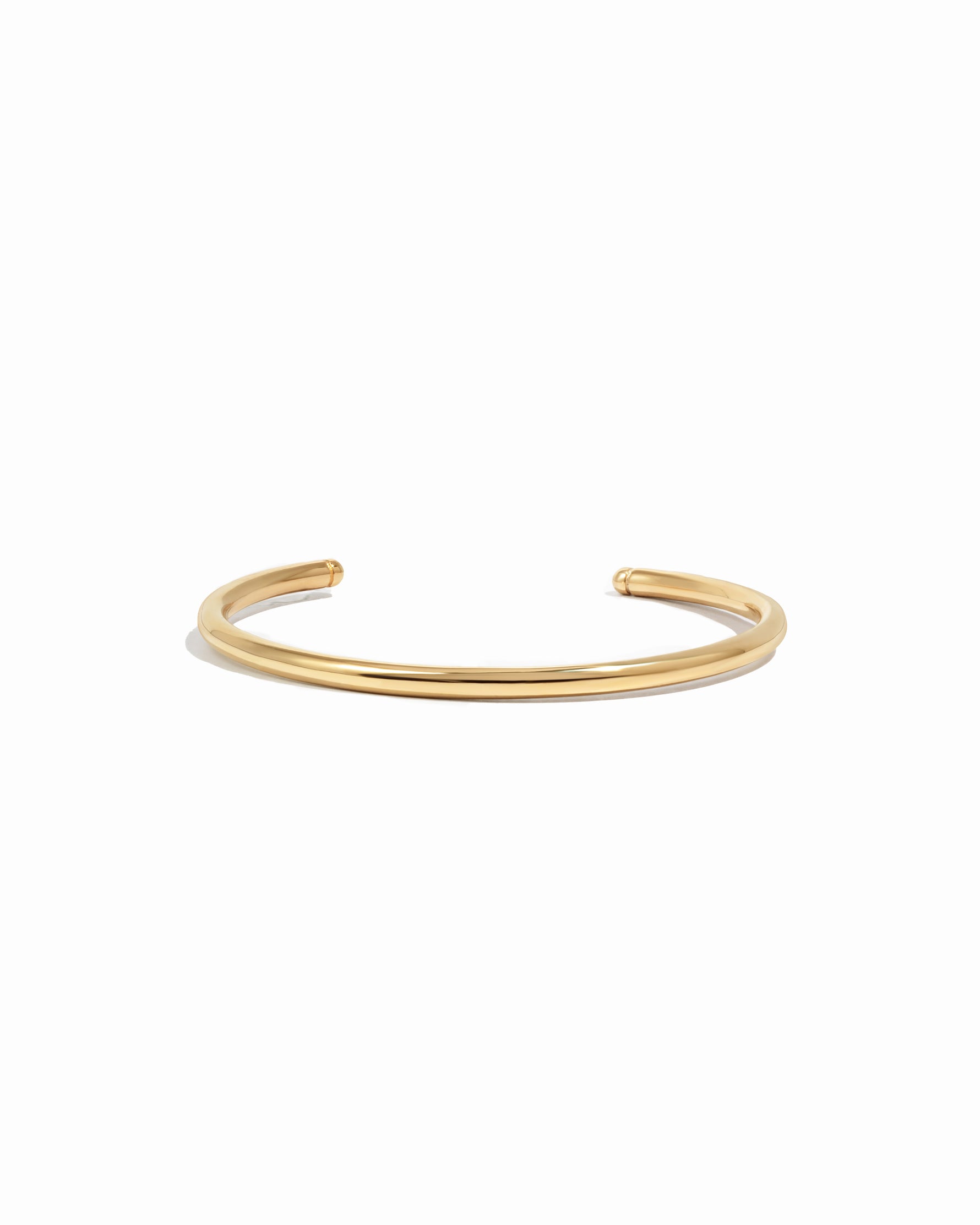 Gold cuff bracelet on a white background 