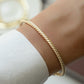 closeup image of gold twisted cuff bangle bracelet
