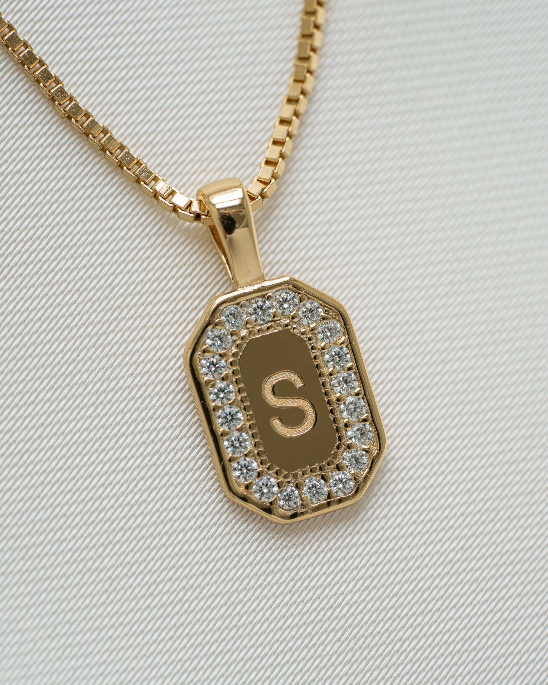 gold custom pendant with cubic zirconia diamond and "S" engraved 