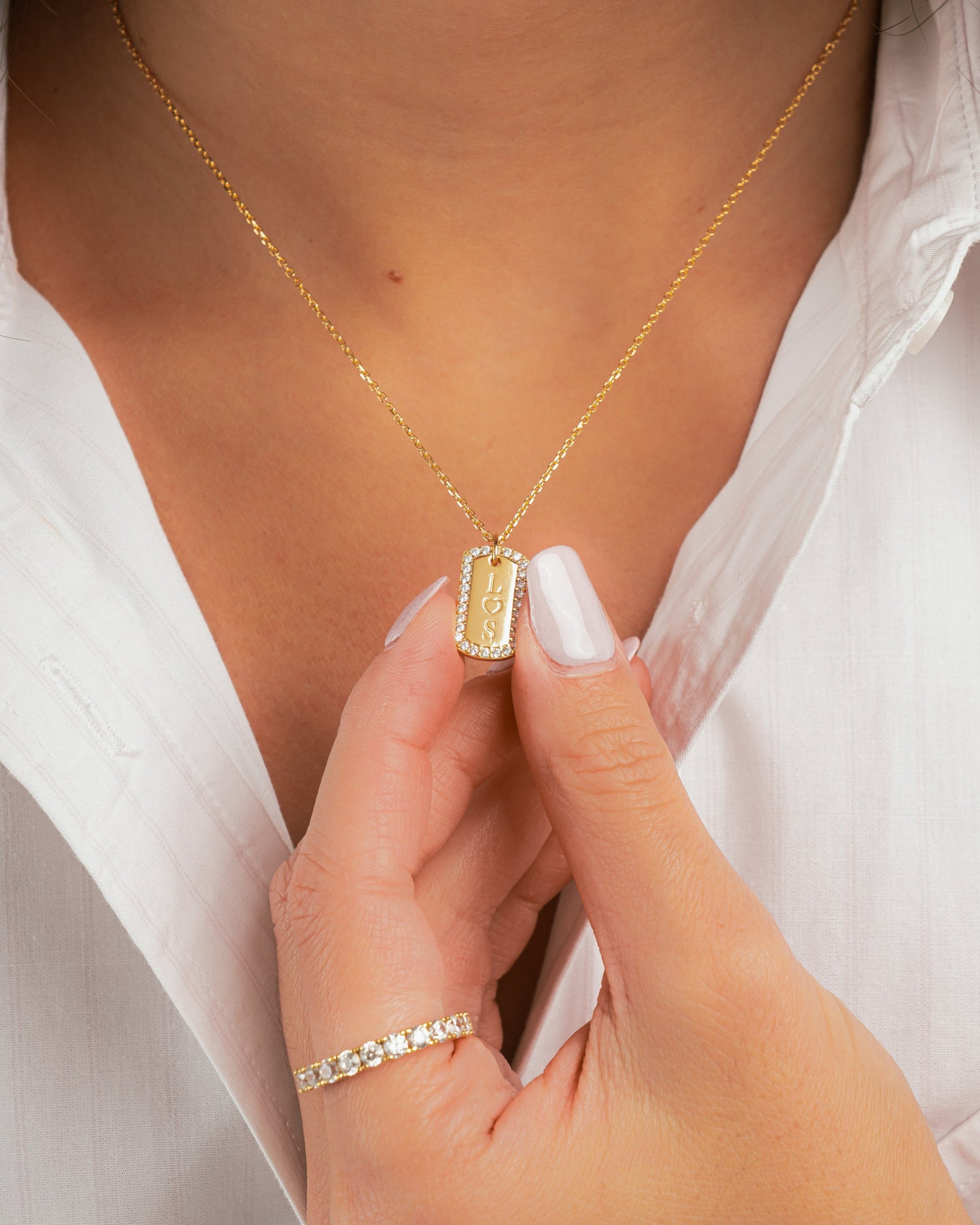 closeup image model showcasing gold initial necklace 
