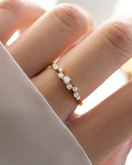 Gold wedding jewelry featuring a curved diamond 