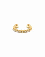 Gold ear cuff with cubic zirconia diamonds on a white background 
