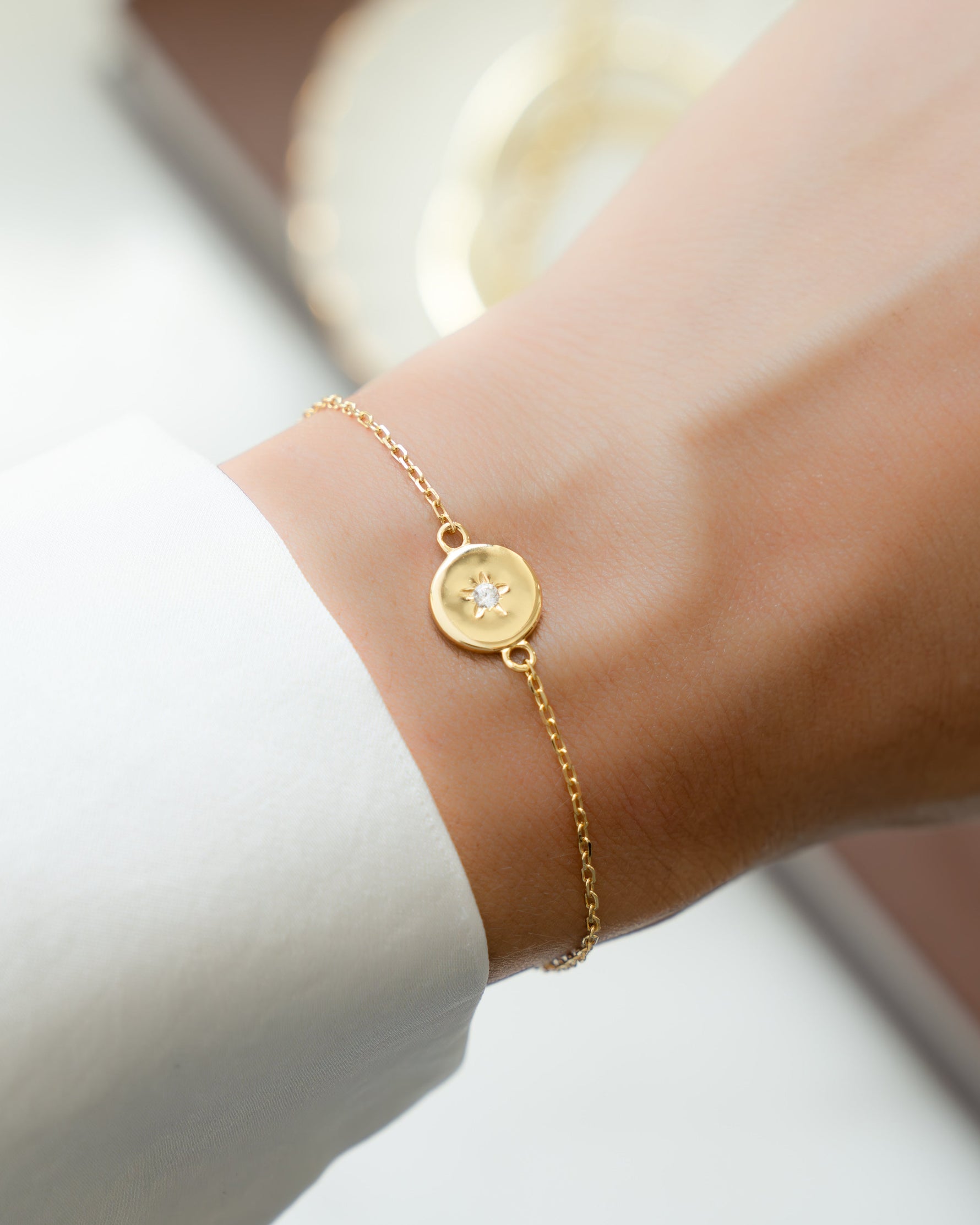 Gold chain charm bracelet on model