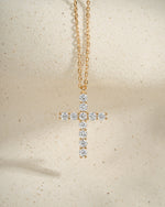 Gold statement necklace with a diamond cross pendant 