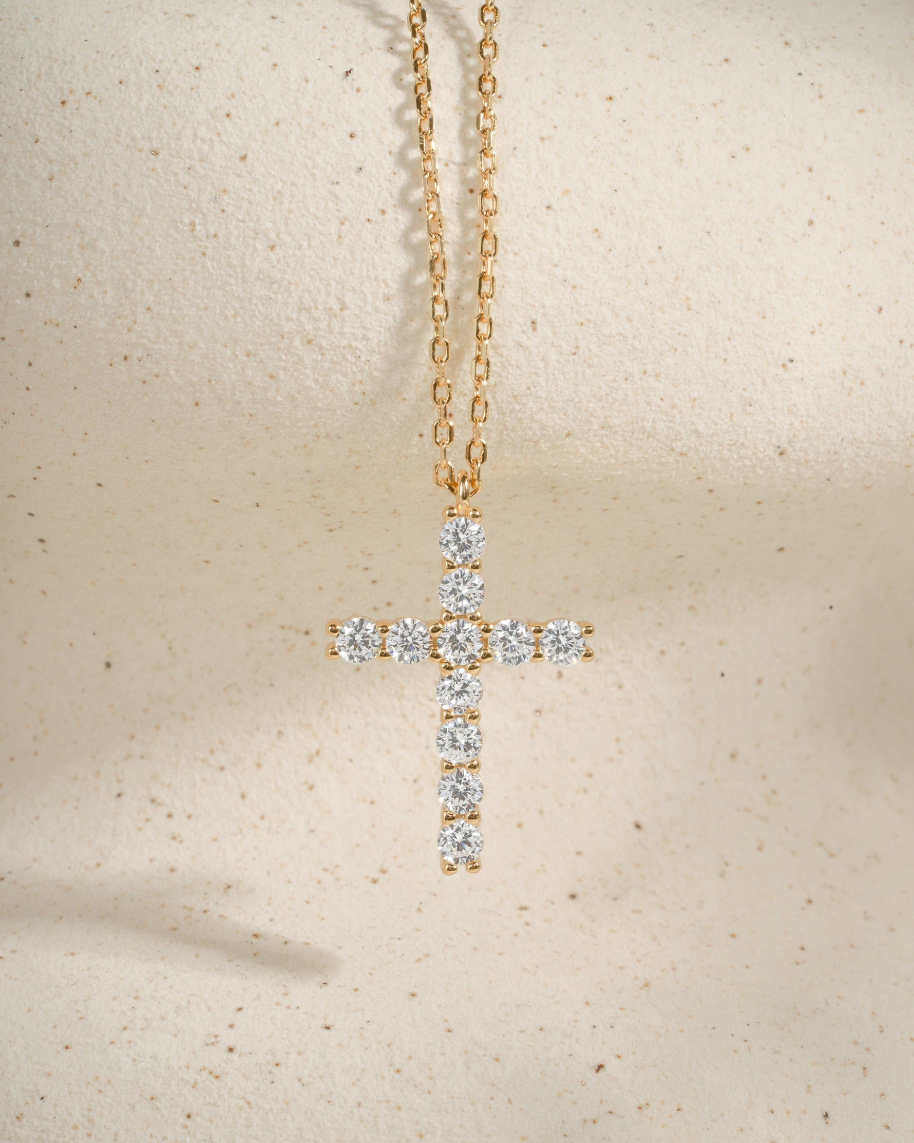 Gold statement necklace with a diamond cross pendant 