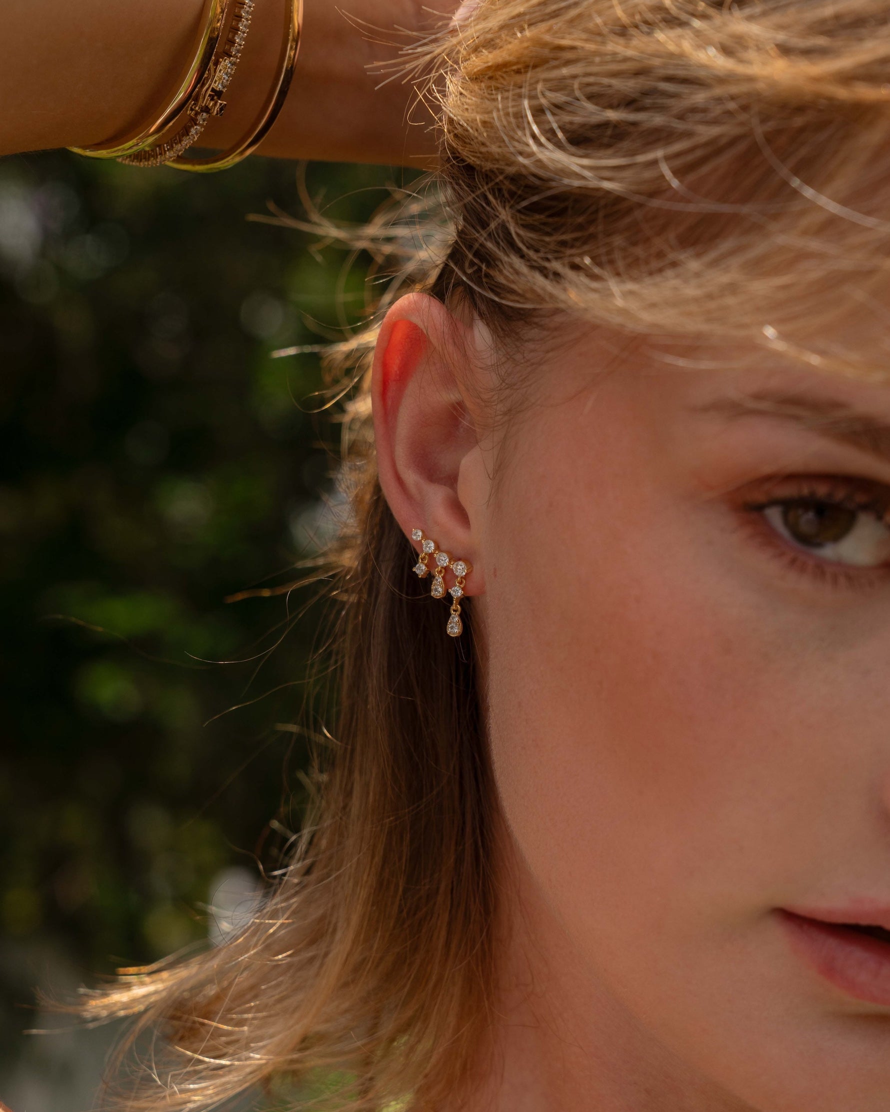 Model wearing dainty drop earrings