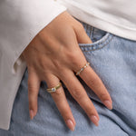 Model wearing gold jewelry with gold minimalist rings