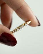Model holding a gold diamond ring 