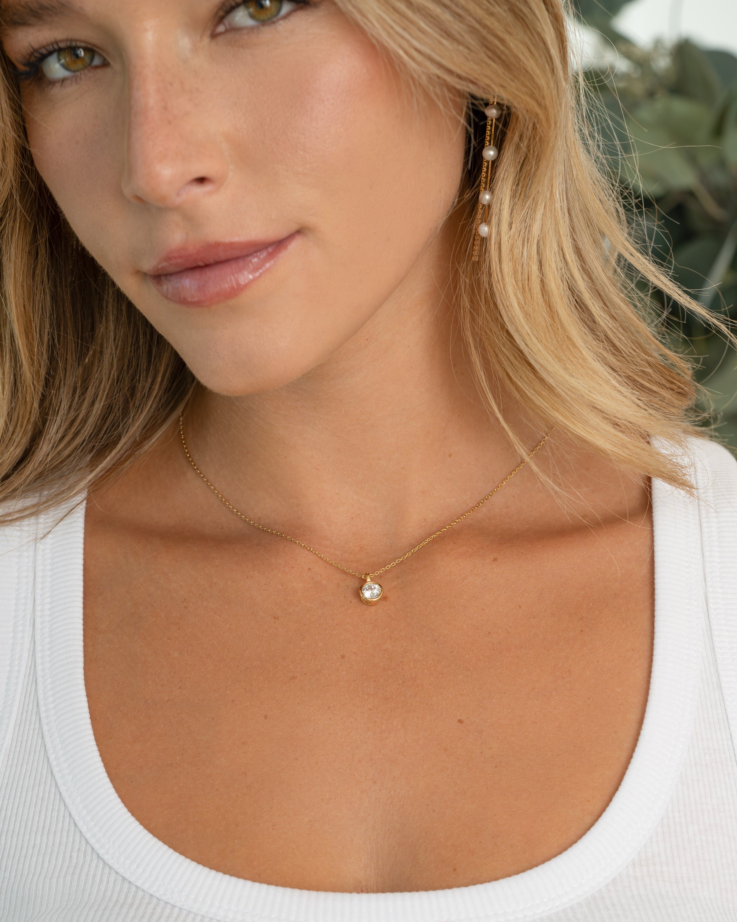 Model wearing gold dainty necklace