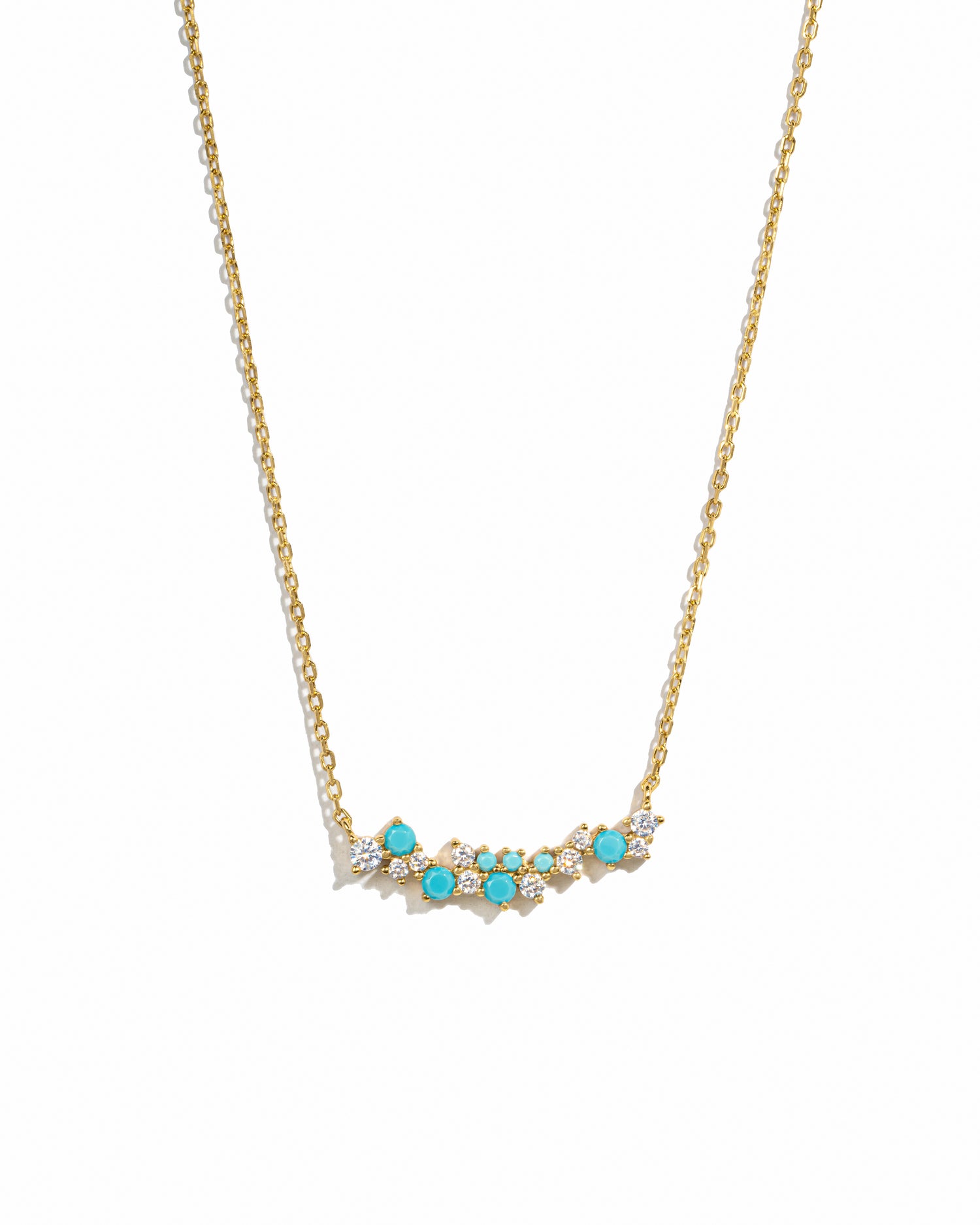 Gold necklace with turquoise stones on a white background