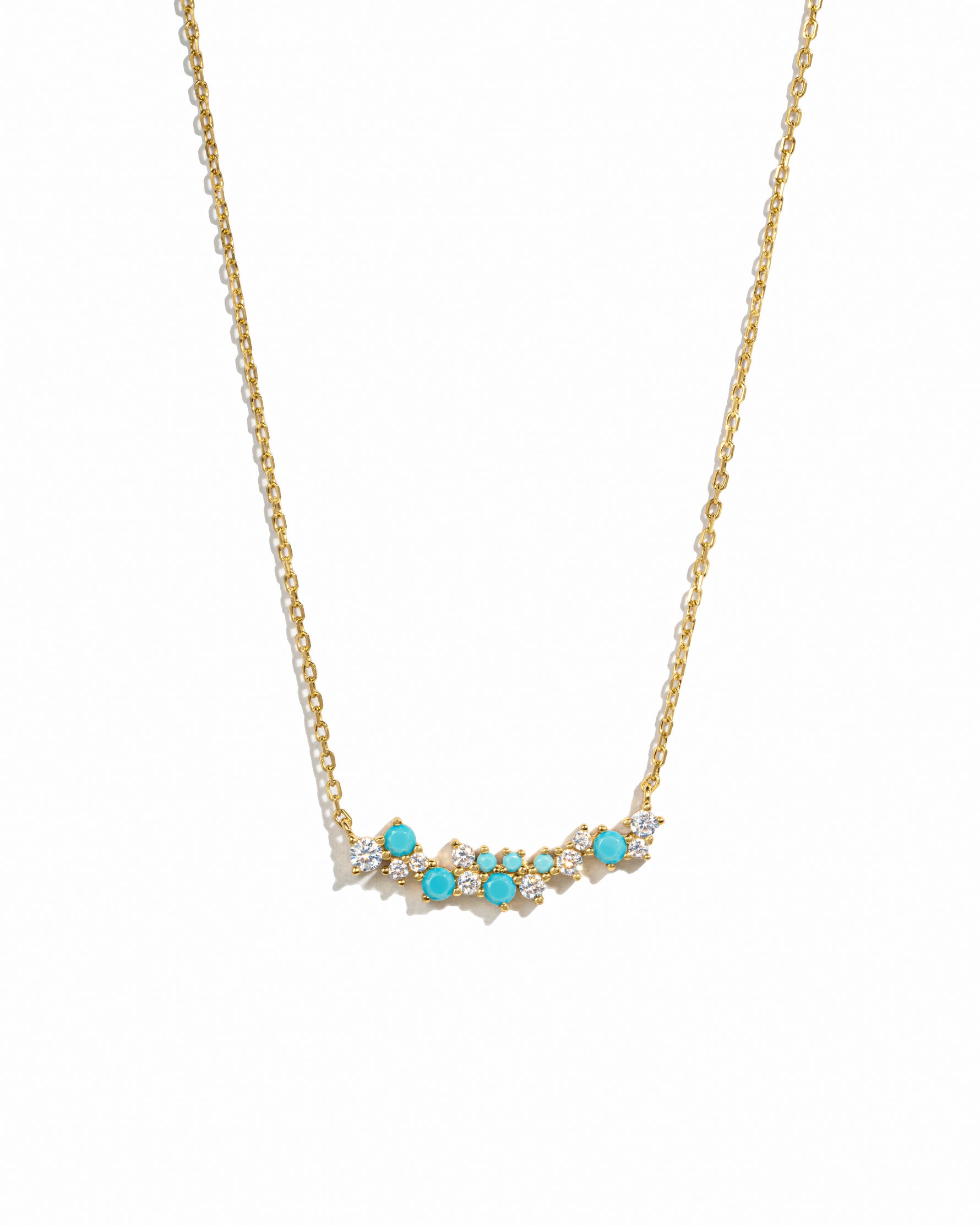 Gold necklace with turquoise stones on a white background