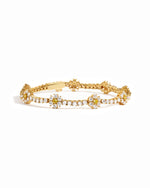 Gold bracelet with floral design on a white background