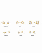 Set of gold earrings with varying sizes on a white background