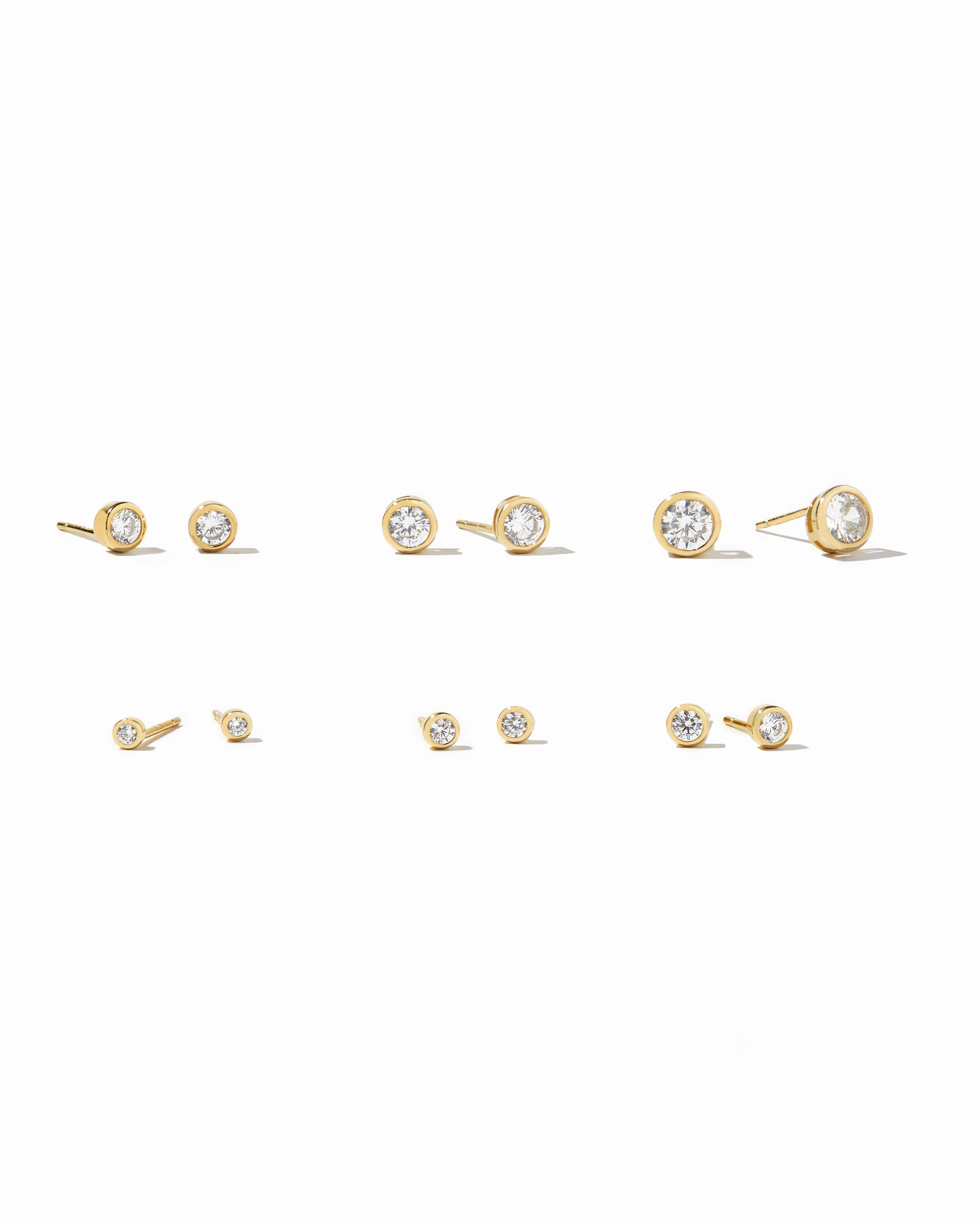 Sami Jewels gold diamond bezel stud earrings in multiple sizes on white background