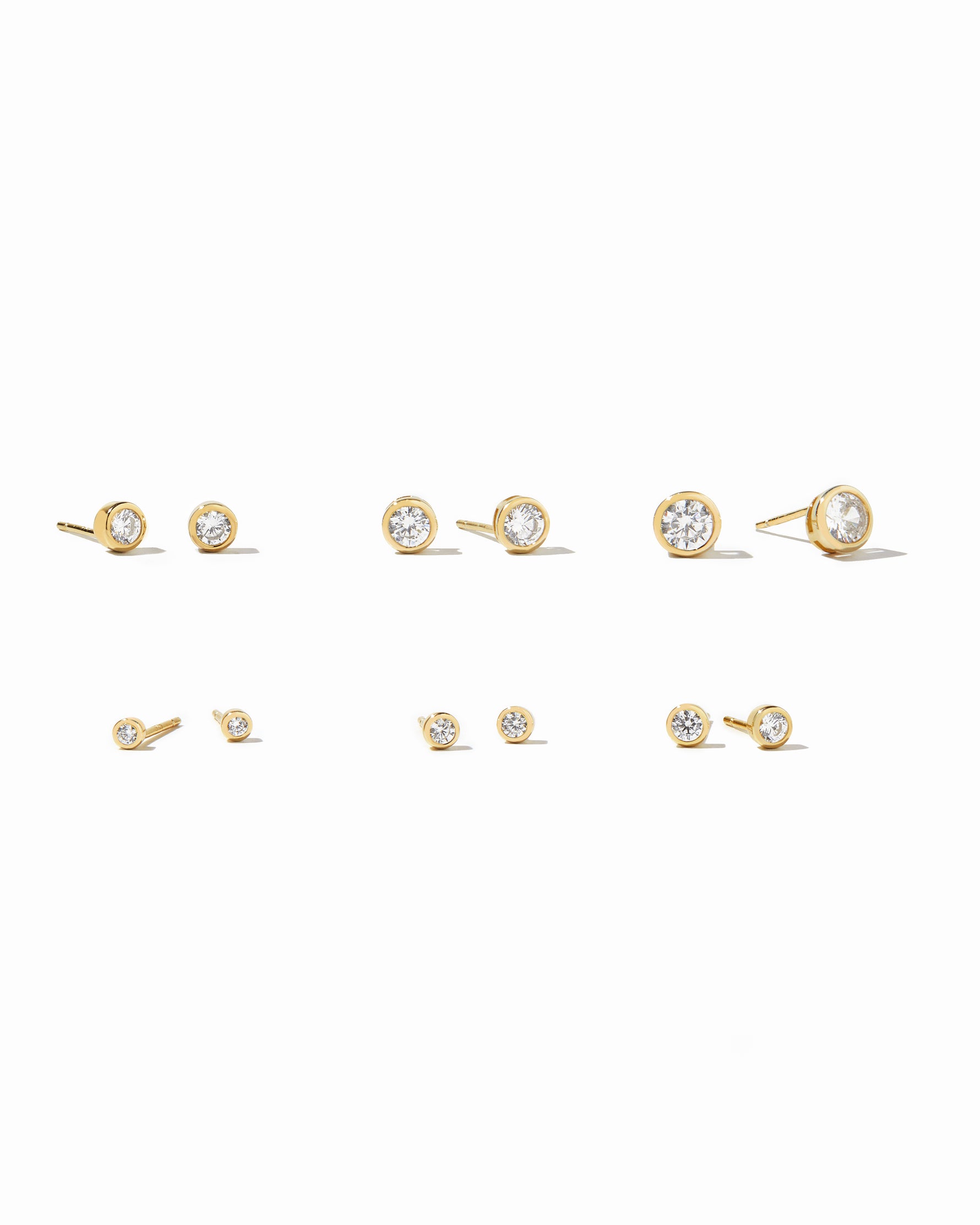 Sami Jewels gold diamond bezel stud earrings in multiple sizes on white background