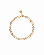 Gold paperclip chain bracelet on a white background