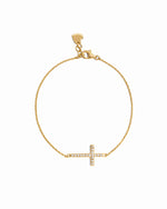 Gold bracelet with a small cross charm on a white background